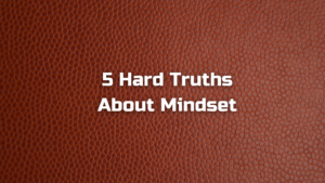 "5 Hard Truths About Mindset" text overlay on a background that looks like a close-up of the texture of a basketball or football.